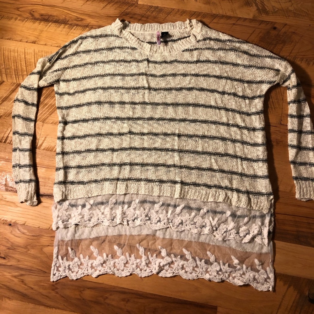 Striped tunic sweater with lace trim.